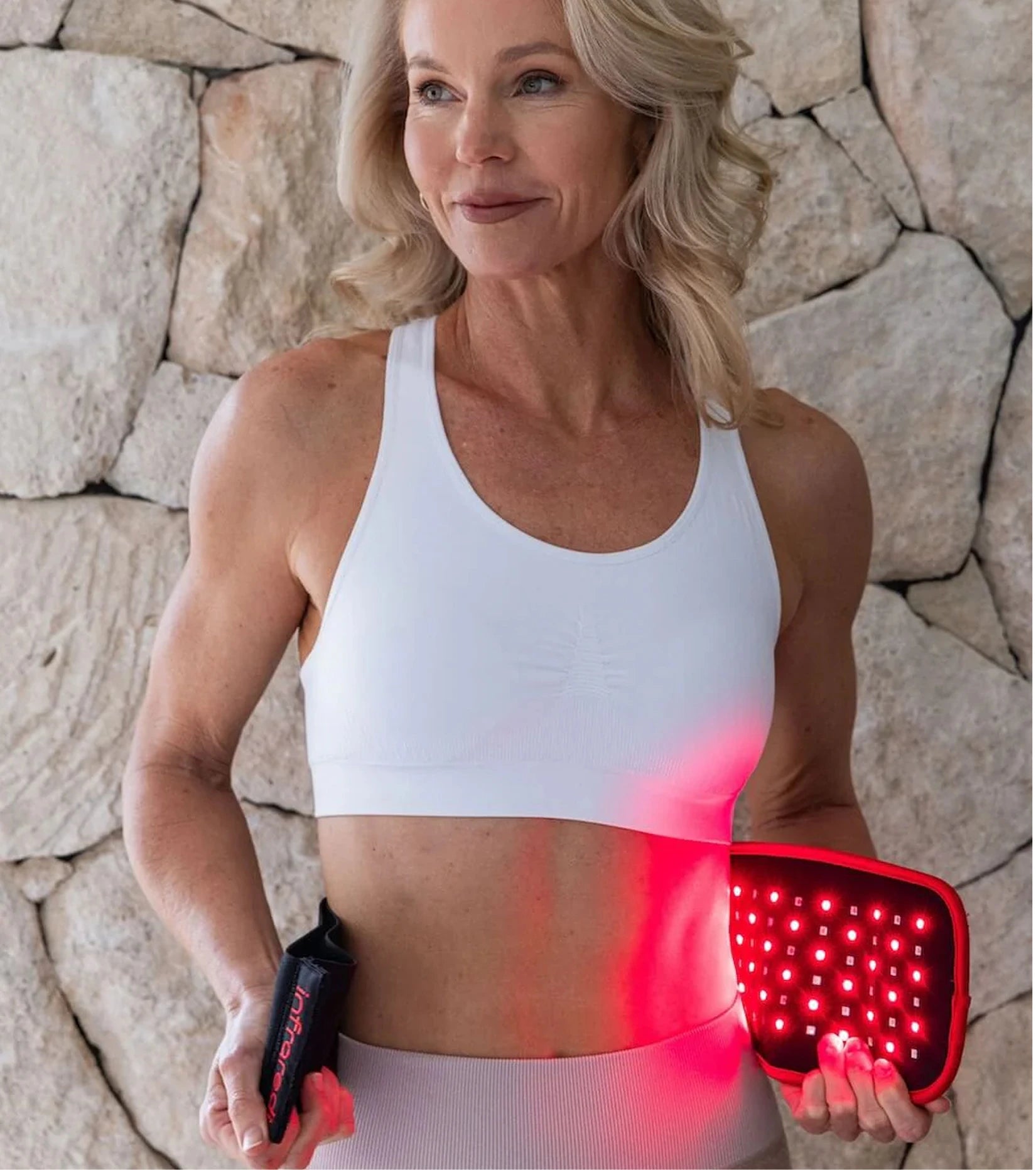 Customer holding an illuminated Infraredi Body Wrap